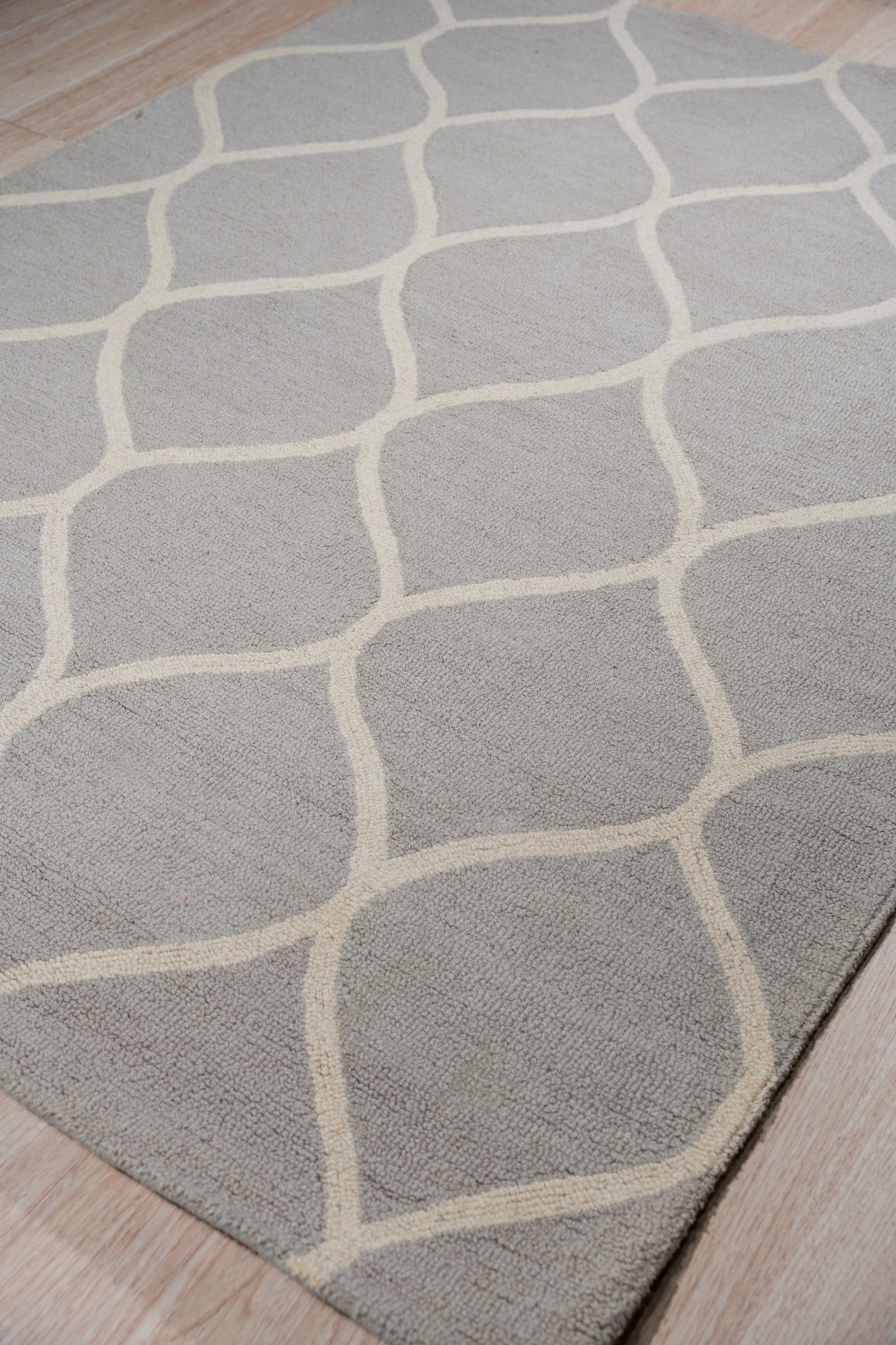 Classic Cozy Light Brown Hand Tufted Wool Rug, a light brown wool rug featuring a subtle textured design, adding warmth to a well-lit living room.