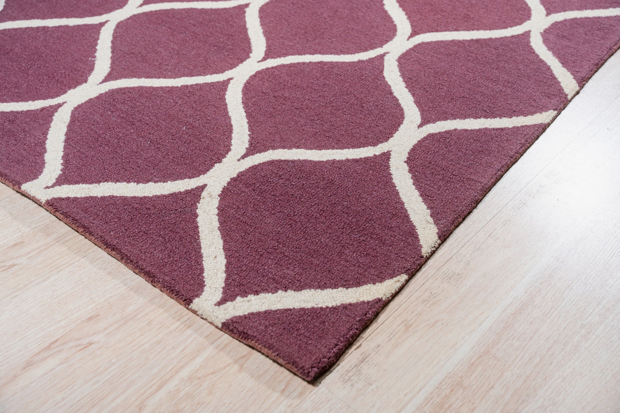 Ava Exquisite Burgundy Hand Tufted Wool Rug, showcasing rich burgundy hues and intricate hand-tufted detailing, lending luxurious warmth and texture to a room setting.