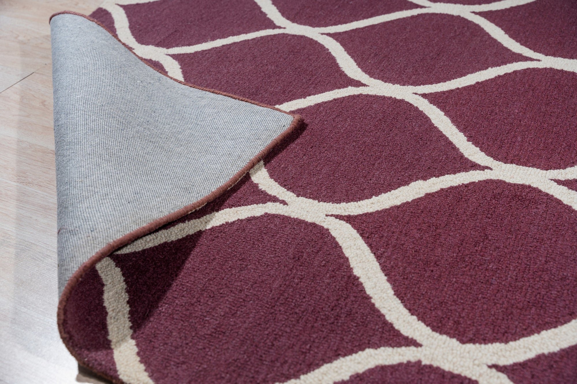 Ava Exquisite Burgundy Hand Tufted Wool Rug, showcasing its rich burgundy hue and intricate hand-tufted detailing, creating a luxurious and warm ambiance in a living room setting.