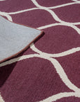 Ava Exquisite Burgundy Hand Tufted Wool Rug, showcasing its rich burgundy hue and intricate hand-tufted detailing, creating a luxurious and warm ambiance in a living room setting.