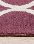 Ava Exquisite Burgundy Hand Tufted Wool Rug, its rich burgundy hues and intricate hand-tufted design showcased within a warm, inviting living space.