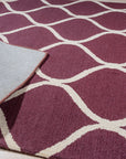Ava Exquisite Burgundy Hand Tufted Wool Rug, its deep burgundy hues and hand-tufted texture showcased in a detailed view, highlighting its luxurious wool construction and intricate pattern.
