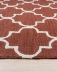 Giselle Iris Brown Hand Tufted Wool Rug, a richly textured hand-tufted wool rug in warm brown hues with subtle iris-inspired floral patterns, displayed in a well-lit living space.
