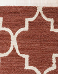 Giselle Iris Brown Hand Tufted Wool Rug, its warm brown tones and intricate floral design unfolding across a light wooden floor. Plush wool fibers invite touch, hand-tufted texture creating depth and dimension within a modern living space.