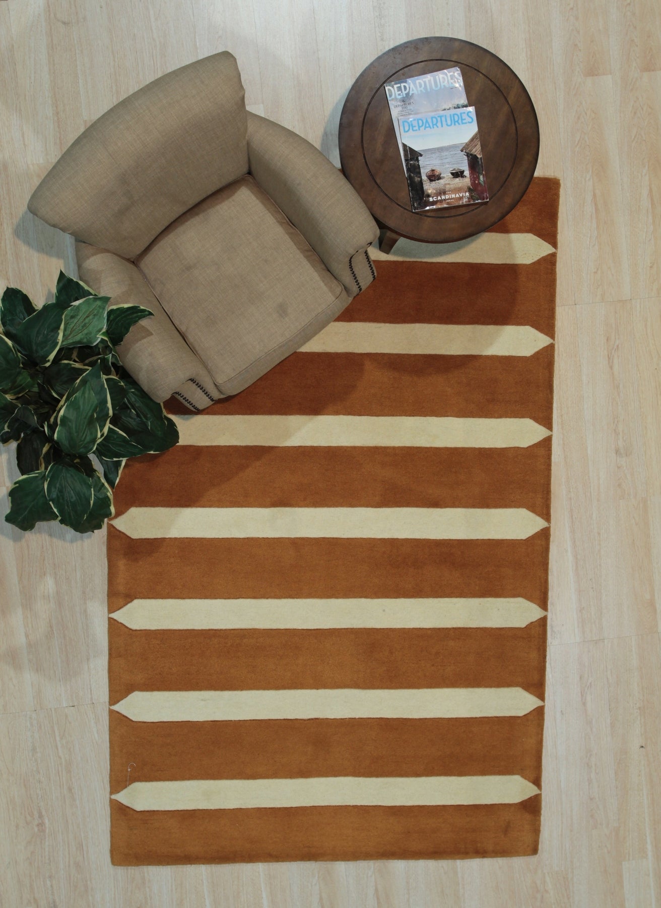Louie Elena Rust Hand Tufted Wool Rug, its warm rust hues and textured hand-tufted construction adding depth and inviting warmth to a contemporary living space.