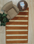 Louie Elena Rust Hand Tufted Wool Rug, its warm rust hues and textured hand-tufted construction adding depth and inviting warmth to a contemporary living space.