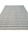 Luxurious Timeless Gray Handmade Wool Rug, its subtle tonal variations and plush texture enhancing a modern living space with a dark wood floor and minimalist decor.