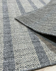 Luxurious Timeless Gray Handmade Wool Rug, grounding a modern living room, its soft gray tones complementing neutral furniture and adding warmth underfoot.