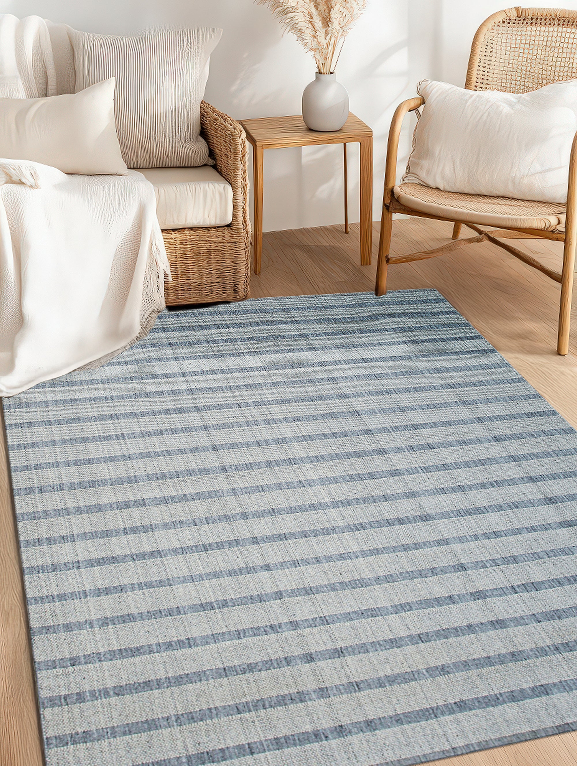 Luxurious Timeless Gray Handmade Wool Rug gracing a light wood floor. Handcrafted texture and subtle gray tones radiate warmth and sophistication. Neutral palette complements a modern, minimalist aesthetic.