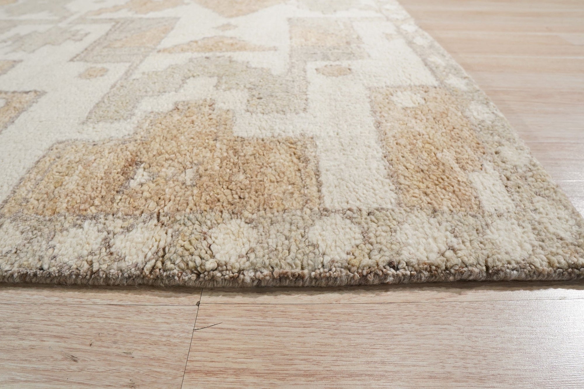 Inviting Oushak Ivory Hand Knotted Wool Rug, showcasing a subtly textured ivory field with a classic Oushak pattern, gently aged and hand-knotted from wool, filling a warmly lit living space.