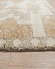 Inviting Oushak Ivory Hand Knotted Wool Rug, showcasing a subtly textured ivory field with a classic Oushak pattern, gently aged and hand-knotted from wool, filling a warmly lit living space.