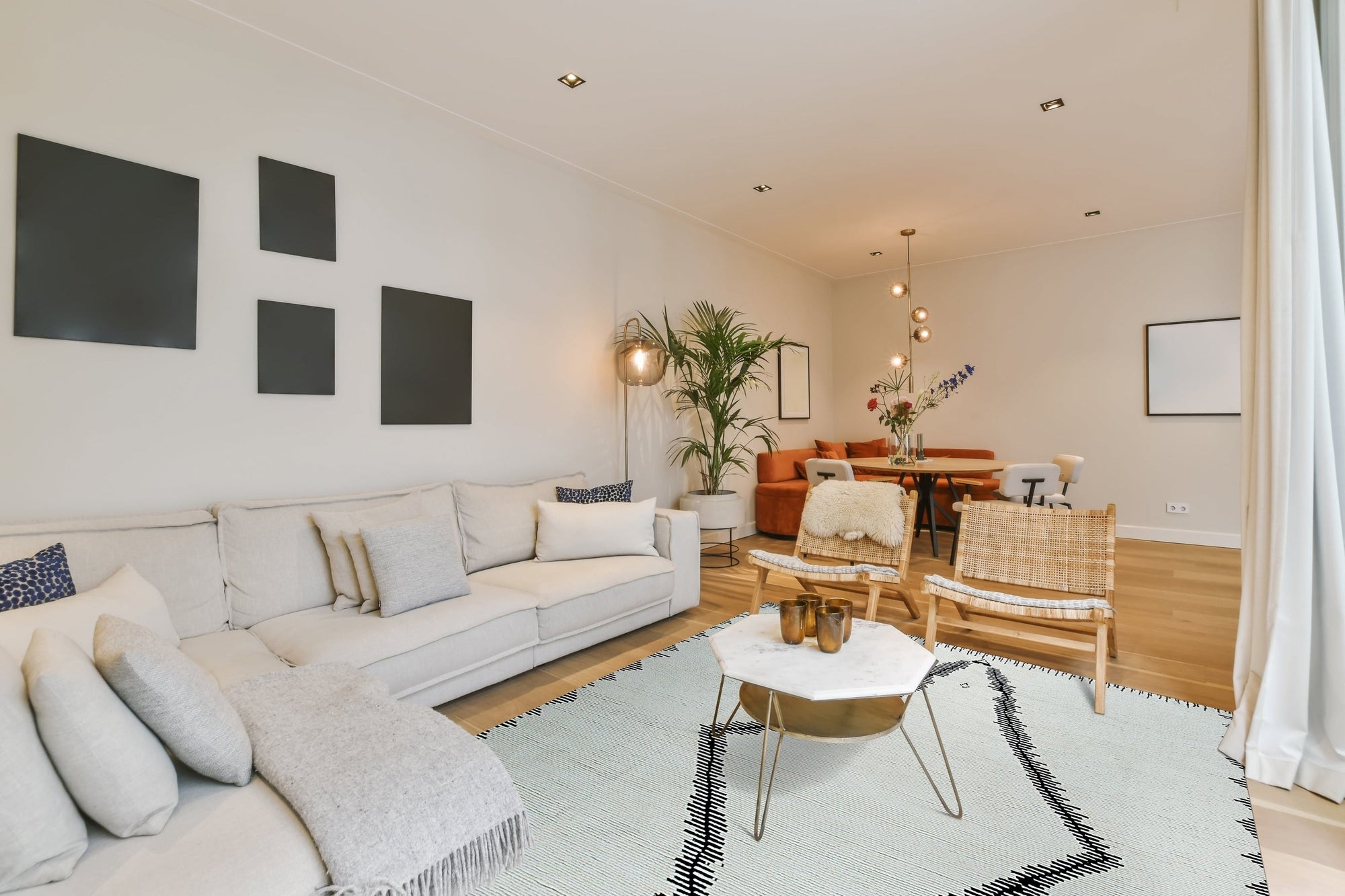 Harlow Moroccan Ivory Hand Knotted Wool Rug, softly textured and ivory-toned, graces a modern living space, its geometric diamond pattern adding subtle depth to the room's neutral palette.