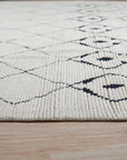 Rhea Diamond Ivory Hand Knotted Wool Rug, soft ivory wool pile with subtle diamond patterns hand-knotted for luxurious texture and refined elegance, displayed in a bright, inviting living space.