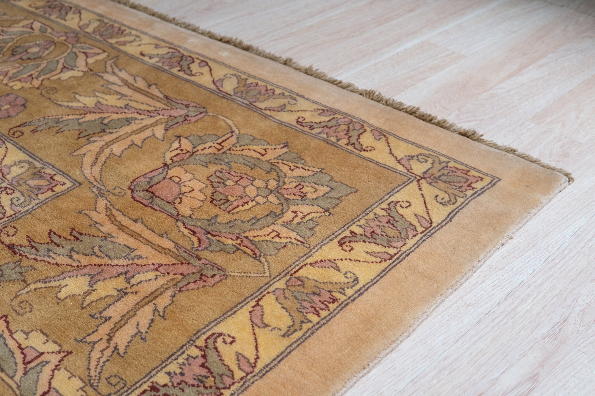 Vibrant Agra Beige Hand Knotted Wool Rug, showcasing intricate floral patterns in warm beige and cream tones, hand-knotted wool lending luxurious texture to a traditional design, seen adding elegance to a well-lit living space.