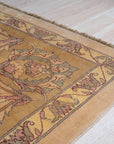 Vibrant Agra Beige Hand Knotted Wool Rug, showcasing intricate floral patterns in warm beige and cream tones, hand-knotted wool lending luxurious texture to a traditional design, seen adding elegance to a well-lit living space.
