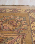 Vibrant Agra Beige Hand Knotted Wool Rug, its intricate pattern and warm beige hues softening a brightly lit living space, hinting at comfortable elegance. Hand-knotted construction is evident in its textured surface.