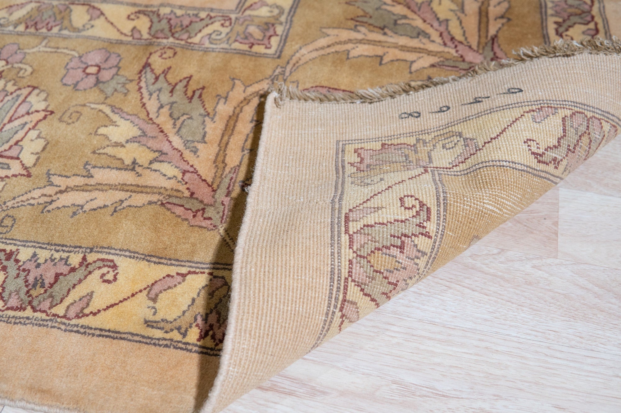 Vibrant Agra Beige Hand Knotted Wool Rug, warm beige tones and intricate floral patterns unfolding across a luxurious hand-knotted wool surface, anchoring a stylish living space.