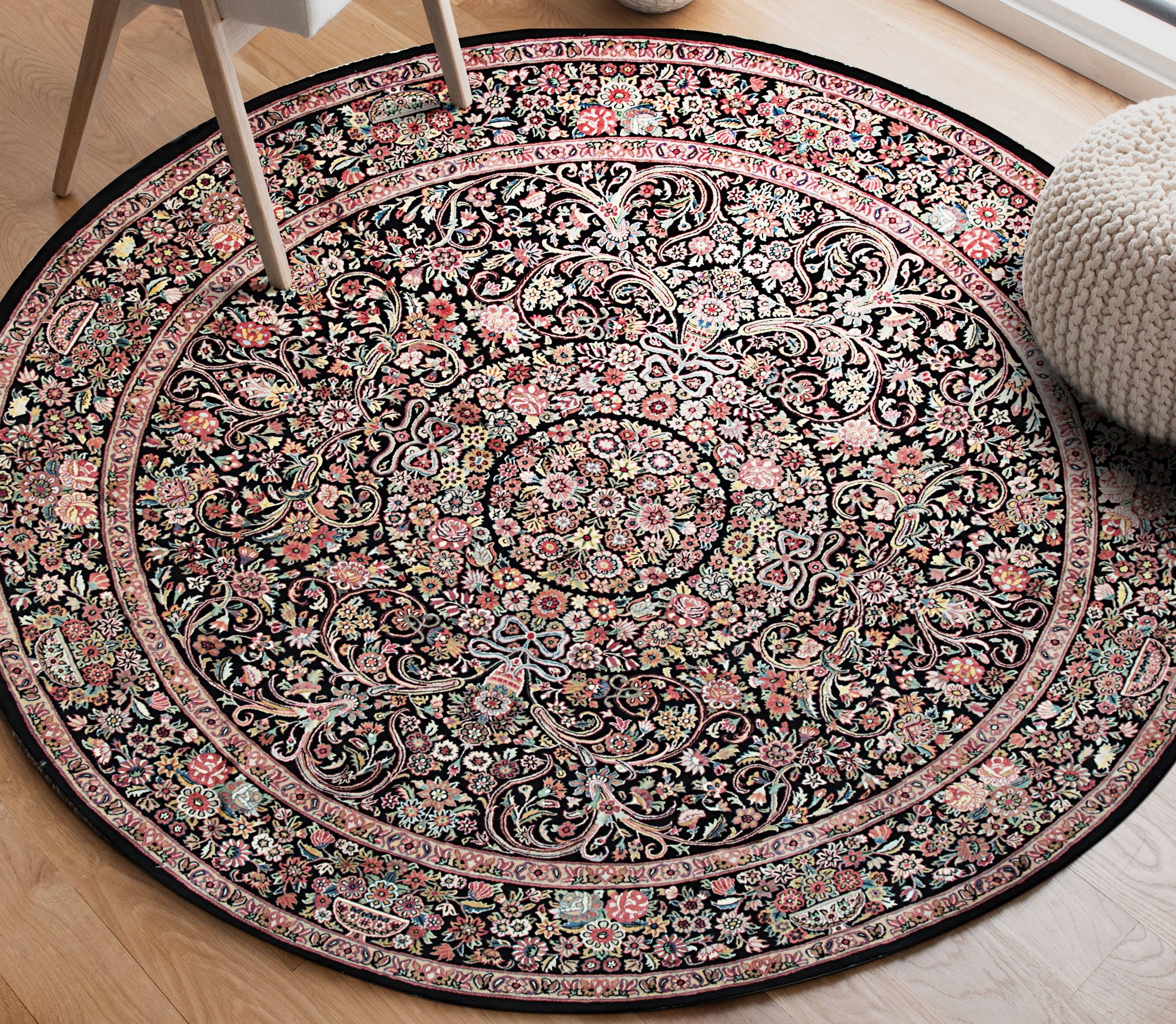 Timeless Inviting Black Hand Knotted Wool Rug, showcasing its rich texture and deep black hue, laid upon a hardwood floor, suggesting warmth and classic elegance in a living space.