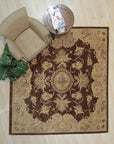 Chic Agra Brown Hand Knotted Wool Rug displayed in a well-lit living space. Woven with brown wool, this hand-knotted rug features an intricate, traditional Agra design, grounding a comfortable seating area.