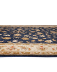 Stylish Peshawar Navy Hand Knotted Wool Rug, its deep navy field punctuated by intricate, traditional geometric patterns, creating a warm and inviting ambiance in a well-lit interior space.