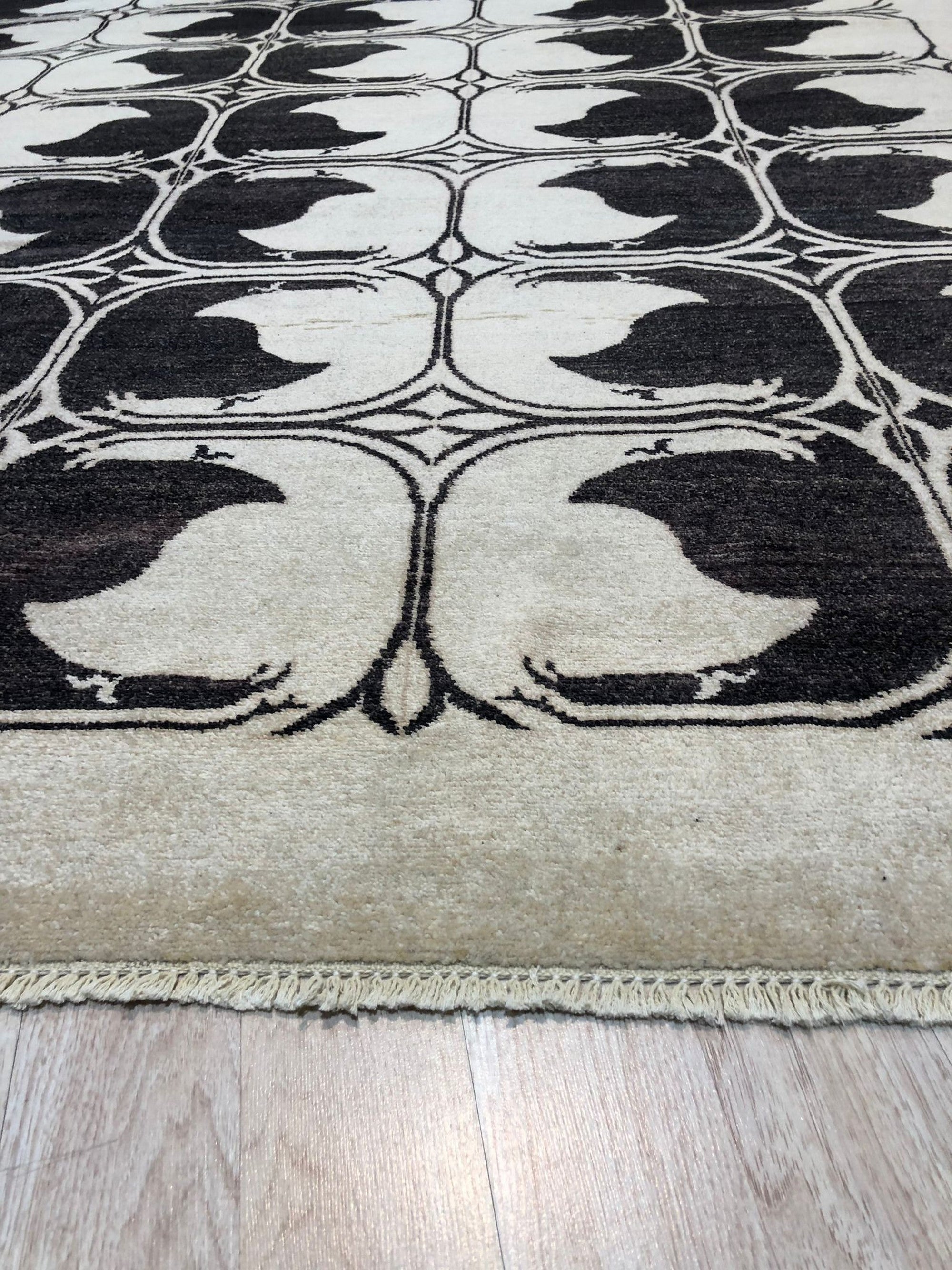 Jade Traditional Ivory Hand Knotted Wool Rug, seen in a bright living space, its intricate ivory patterns offering a soft, luxurious texture underfoot.