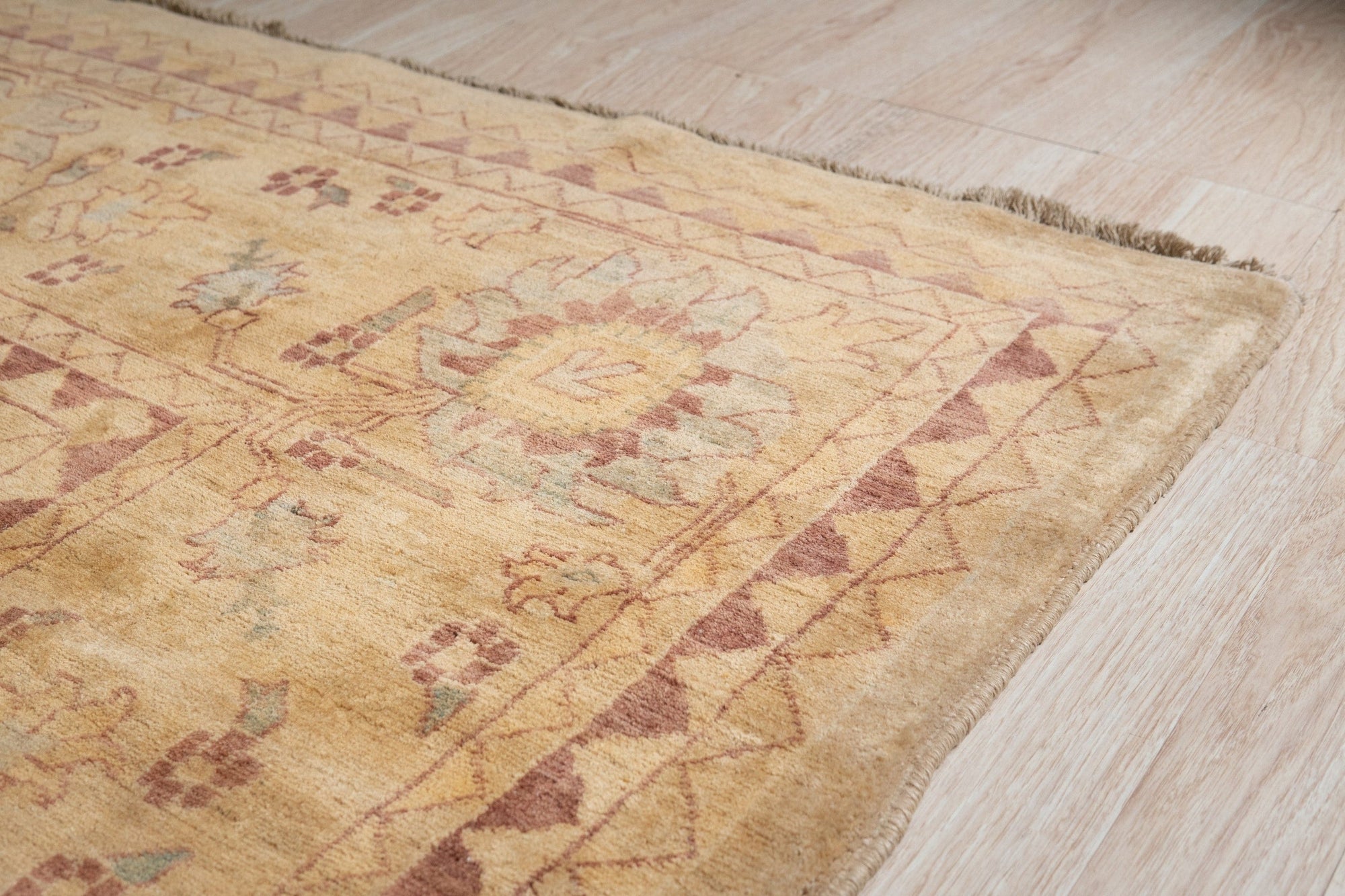 Violet Elegant Beige Hand Knotted Wool Rug, showcasing intricate floral and geometric patterns in soft beige and violet hues, with visible hand-knotted texture and fringe detail.