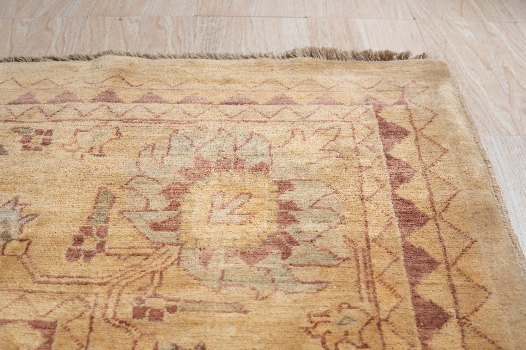 Violet Elegant Beige Hand Knotted Wool Rug, showcasing a subtle floral pattern in soft beige tones, hand-knotted from wool, inviting warmth and elegance into the room.