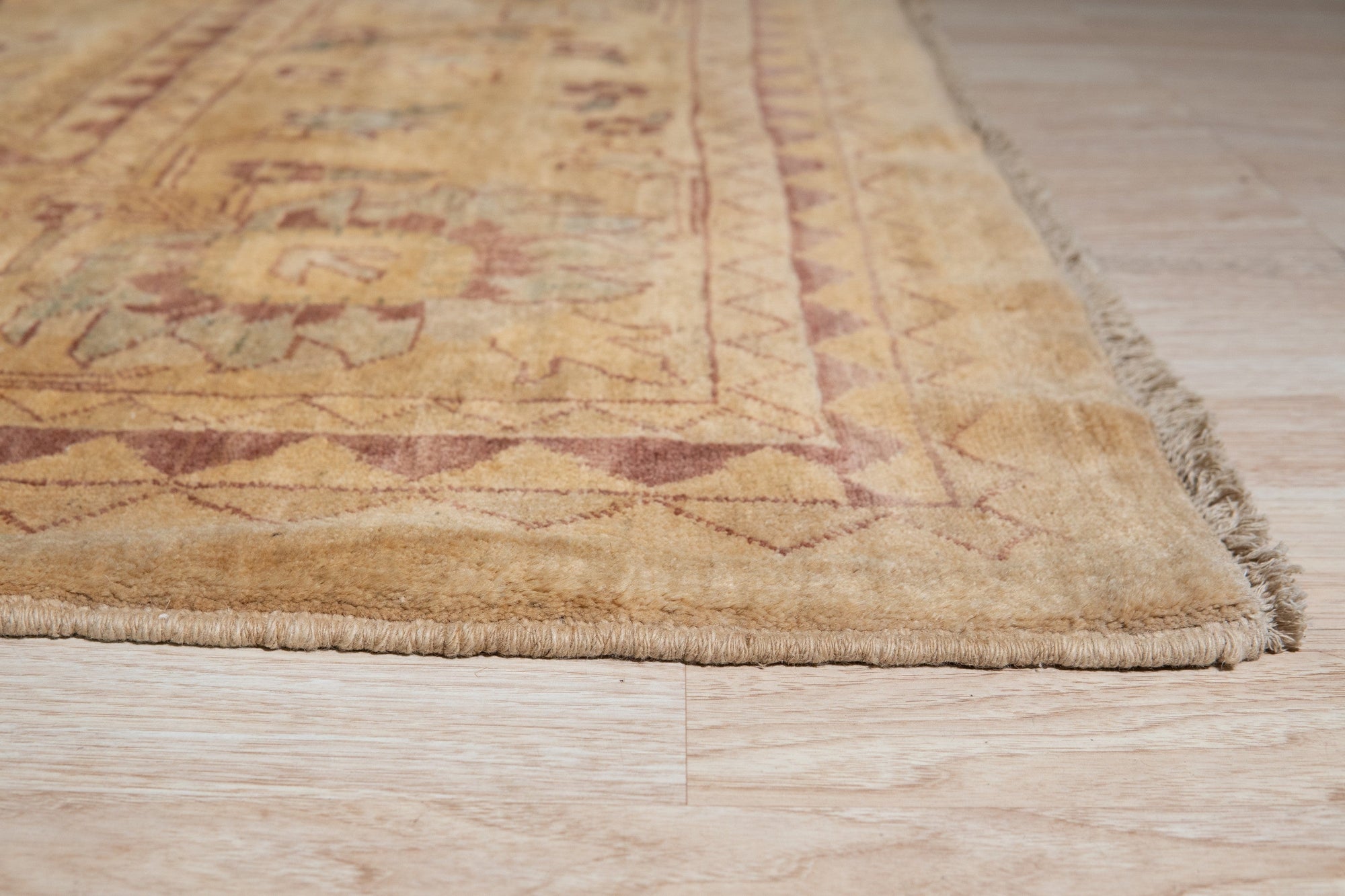 Violet Elegant Beige Hand Knotted Wool Rug, soft beige backdrop intricately woven with violet accents, seen adding warmth and elegance to a living space.