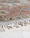 Comfortable Timeless Ivory Hand Knotted Wool Rug, showcasing soft ivory tones and intricate hand-knotted texture, rests on a light wood floor, suggesting warmth and understated elegance in a minimalist setting.