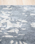 Amara Rhea Ivory Hand Knotted Rug, displaying intricate knotted construction and soft ivory hues, situated in a well-lit interior setting.