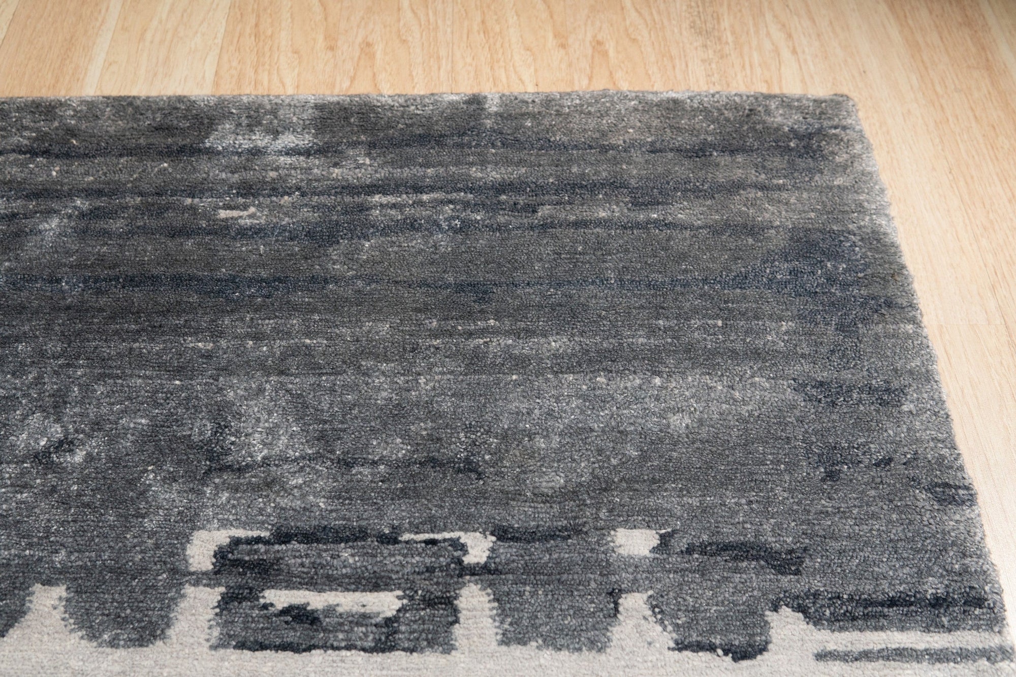 Graceful Classic Gray Hand Knotted Wool & Viscose Rug, soft gray hues and subtle sheen create an elegant foundation in a modern living room setting.