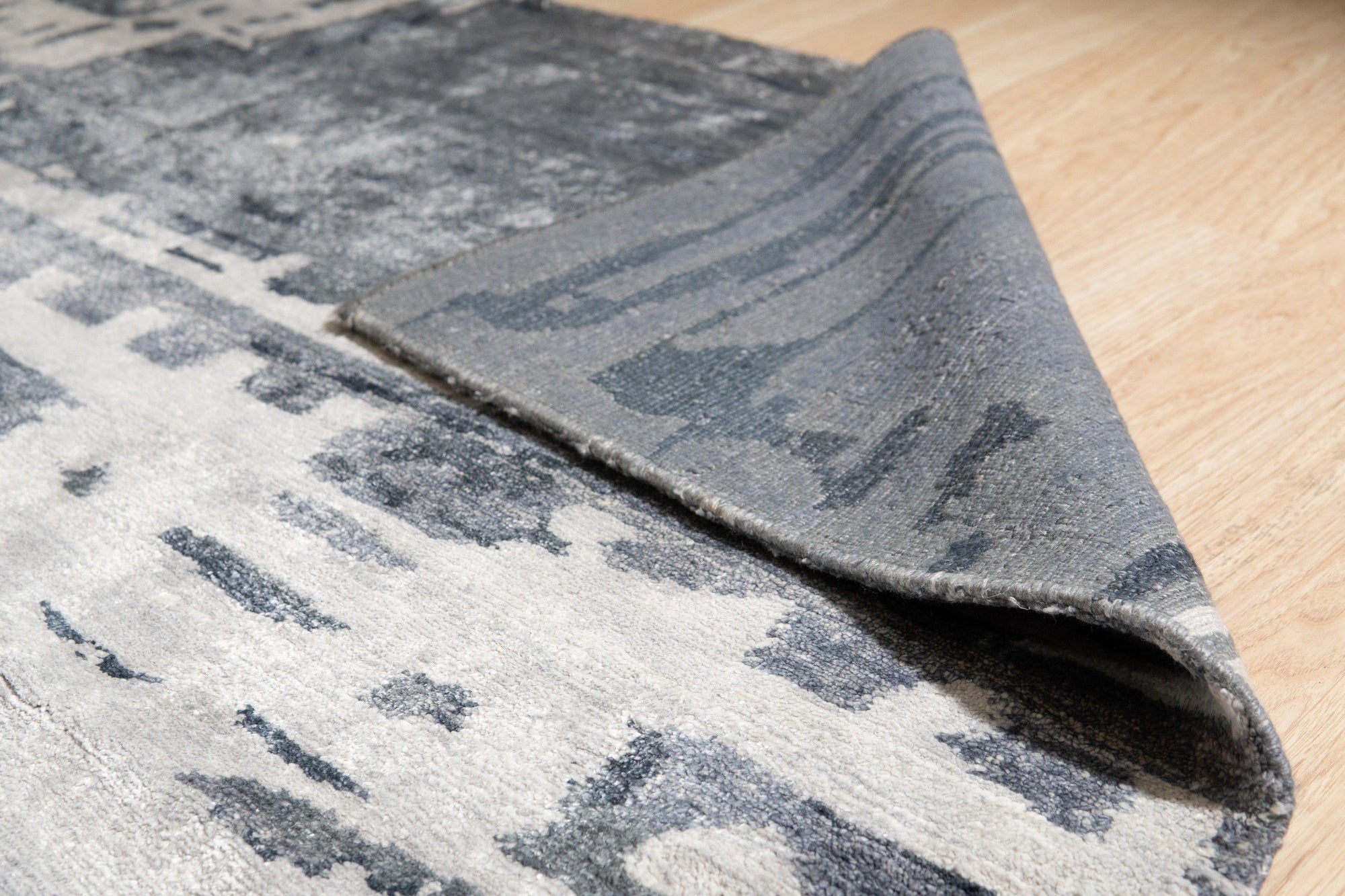 Graceful Classic Gray Hand Knotted Wool & Viscose Rug, showing intricate patterns and a subtle sheen in a softly lit room.