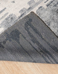 Graceful Classic Gray Hand Knotted Wool & Viscose Rug, blending muted gray tones in a classic, hand-knotted design, graces a modern living space with hardwood floors and subtle natural light.