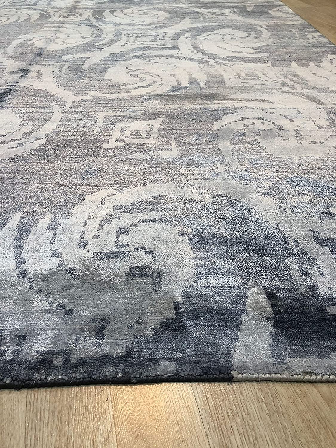 Comfortable Nina Blue Hand Knotted Wool & Bamboo Silk Rug, a blue and silk rug with a modern design, seen in a living room setting.