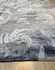 Comfortable Nina Blue Hand Knotted Wool & Bamboo Silk Rug, a blue and silk rug with a modern design, seen in a living room setting.