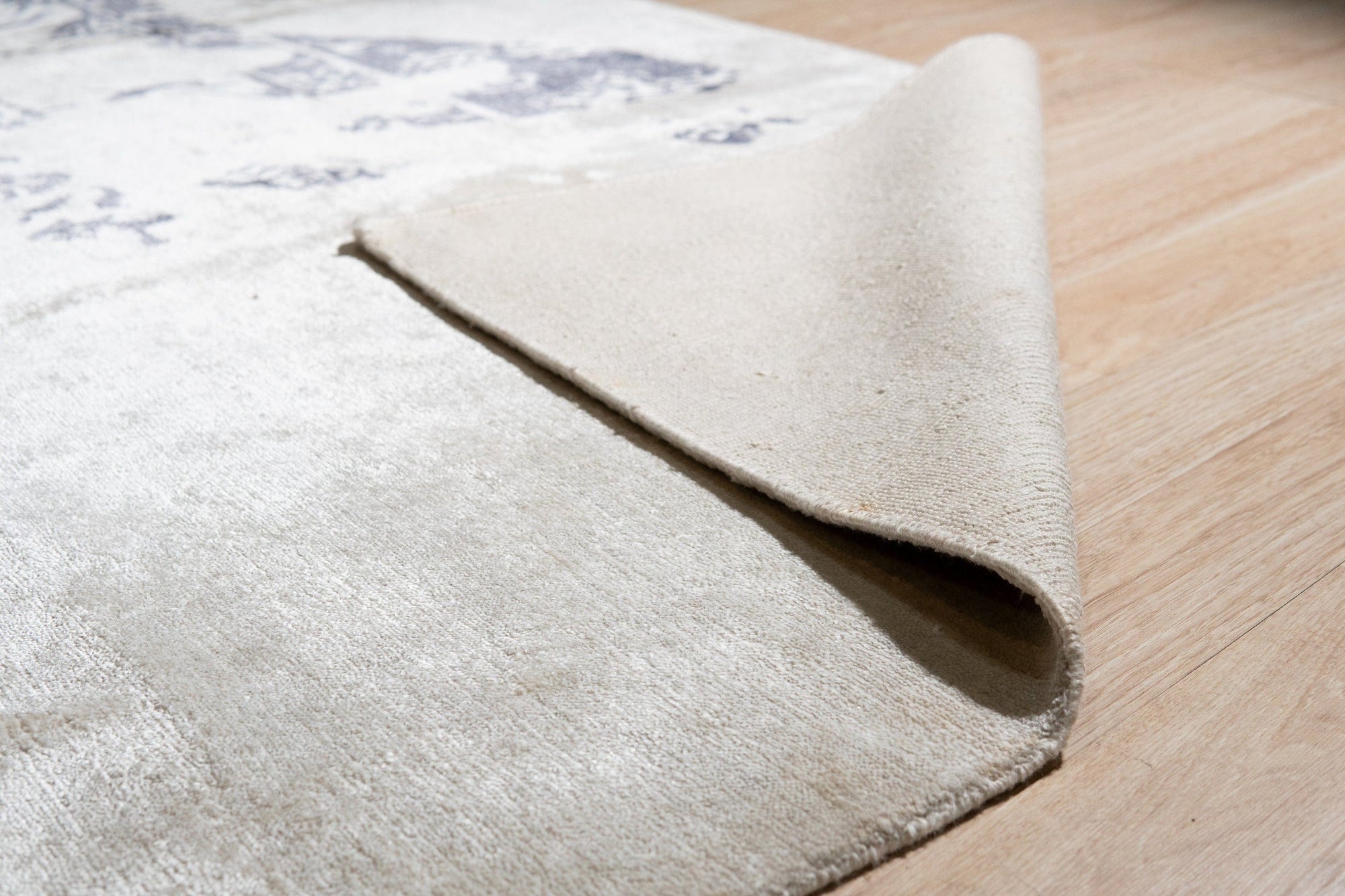 Ella Chic Ivory Hand Knotted Rug, soft ivory tones and subtle texture create a serene and elegant foundation in a bright living space.