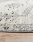 Amara Oushak Ivory Hand Knotted Wool Rug, showcasing intricate floral patterns and soft ivory tones, nestled within a brightly lit living space.