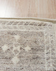 Celia Oushak Gray Hand Knotted Wool Rug, blending muted grays in a traditional Oushak design, graces a sunlit living room, its hand-knotted wool offering inviting texture beneath a coffee table.