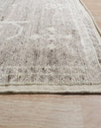 Celia Oushak Gray Hand Knotted Wool Rug, showcasing intricate traditional patterns in soft grays, lies elegantly on a light wood floor, inviting warmth and classic style into the room.