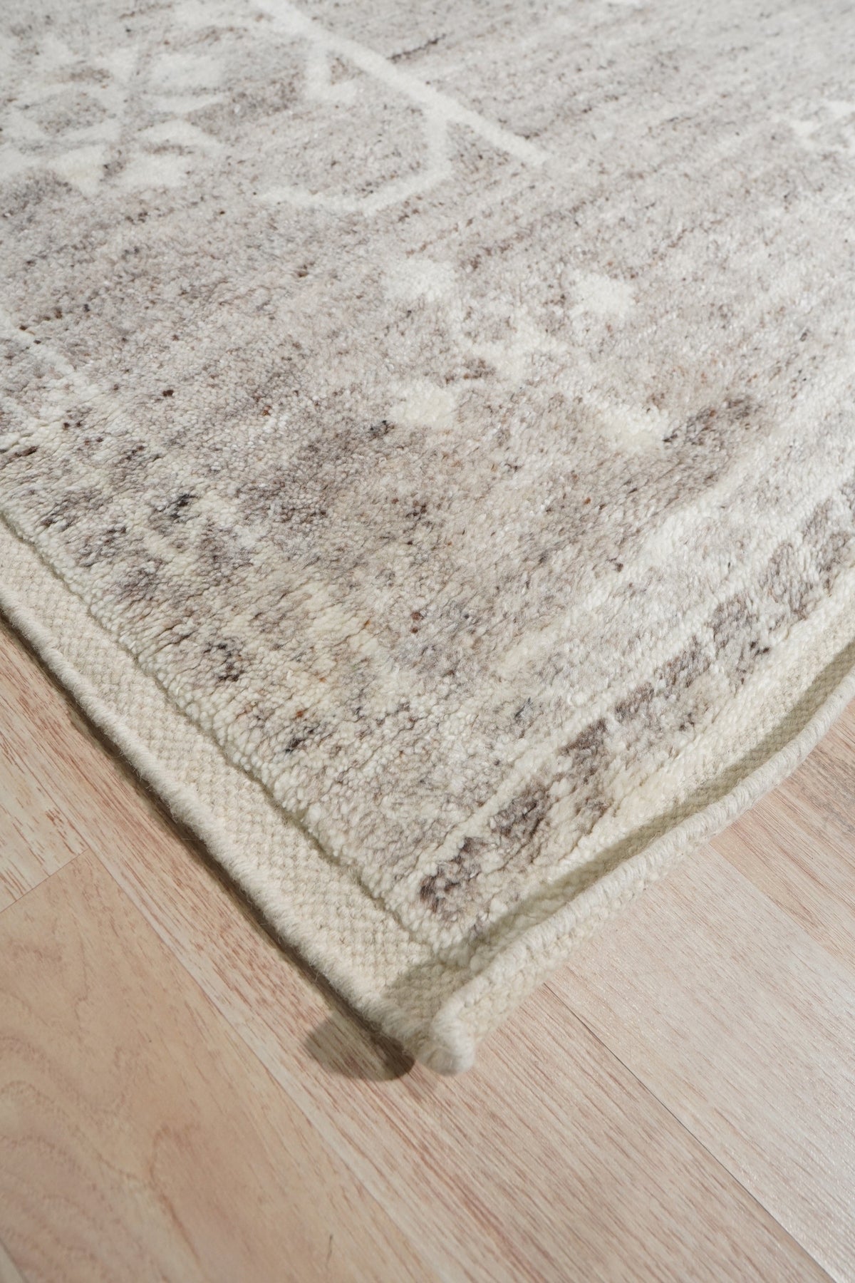 Celia Oushak Gray Hand Knotted Wool Rug, its intricate design a blend of traditional Oushak motifs and modern gray tones, sits invitingly in a well-lit room.