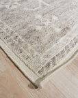 Celia Oushak Gray Hand Knotted Wool Rug, its intricate design a blend of traditional Oushak motifs and modern gray tones, sits invitingly in a well-lit room.