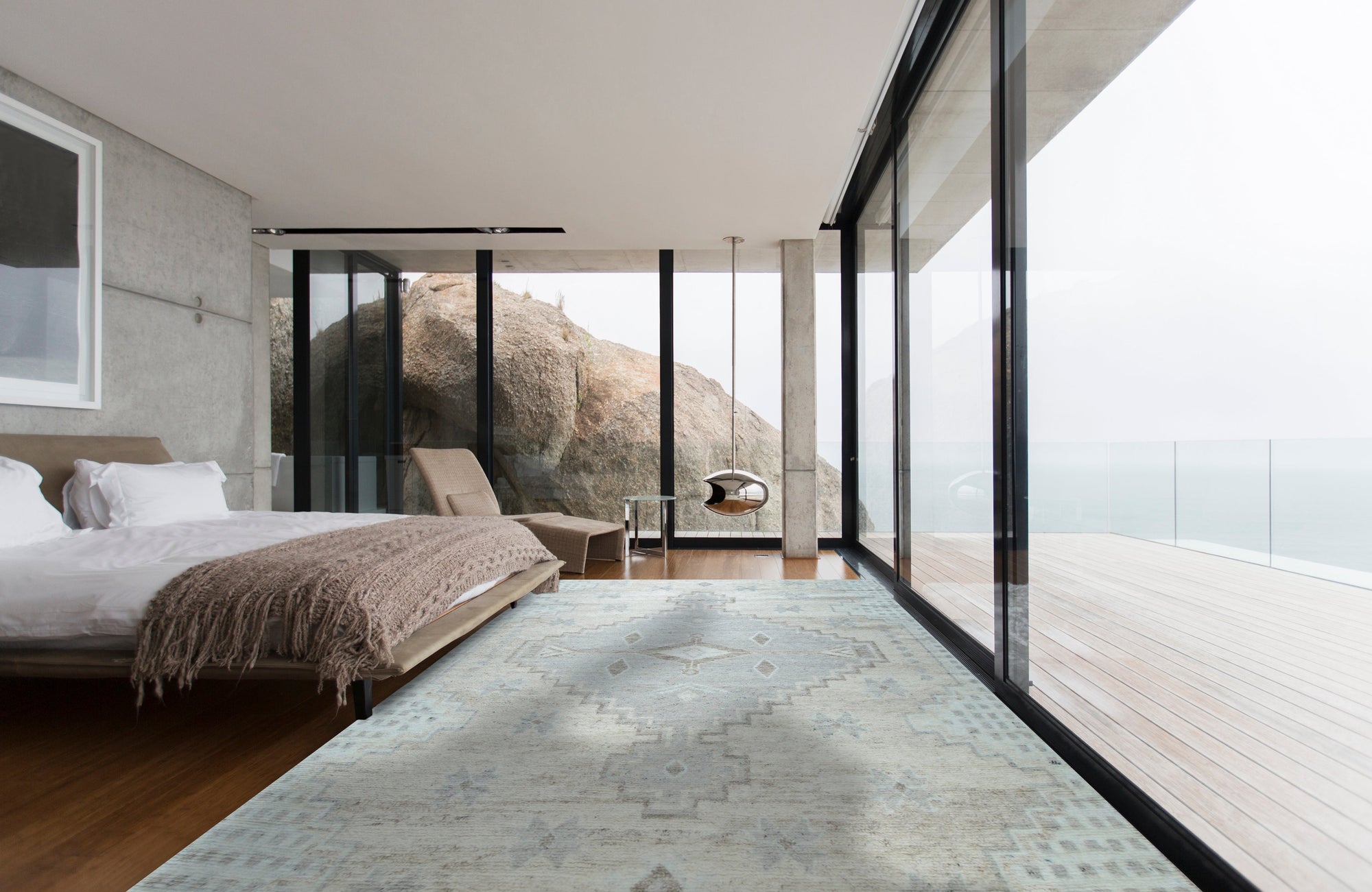Talia Oushak Ivory Hand Knotted Wool Rug, showcasing intricate floral patterns and delicate hues of ivory in a bright living space, accenting a modern sofa and wooden coffee table.