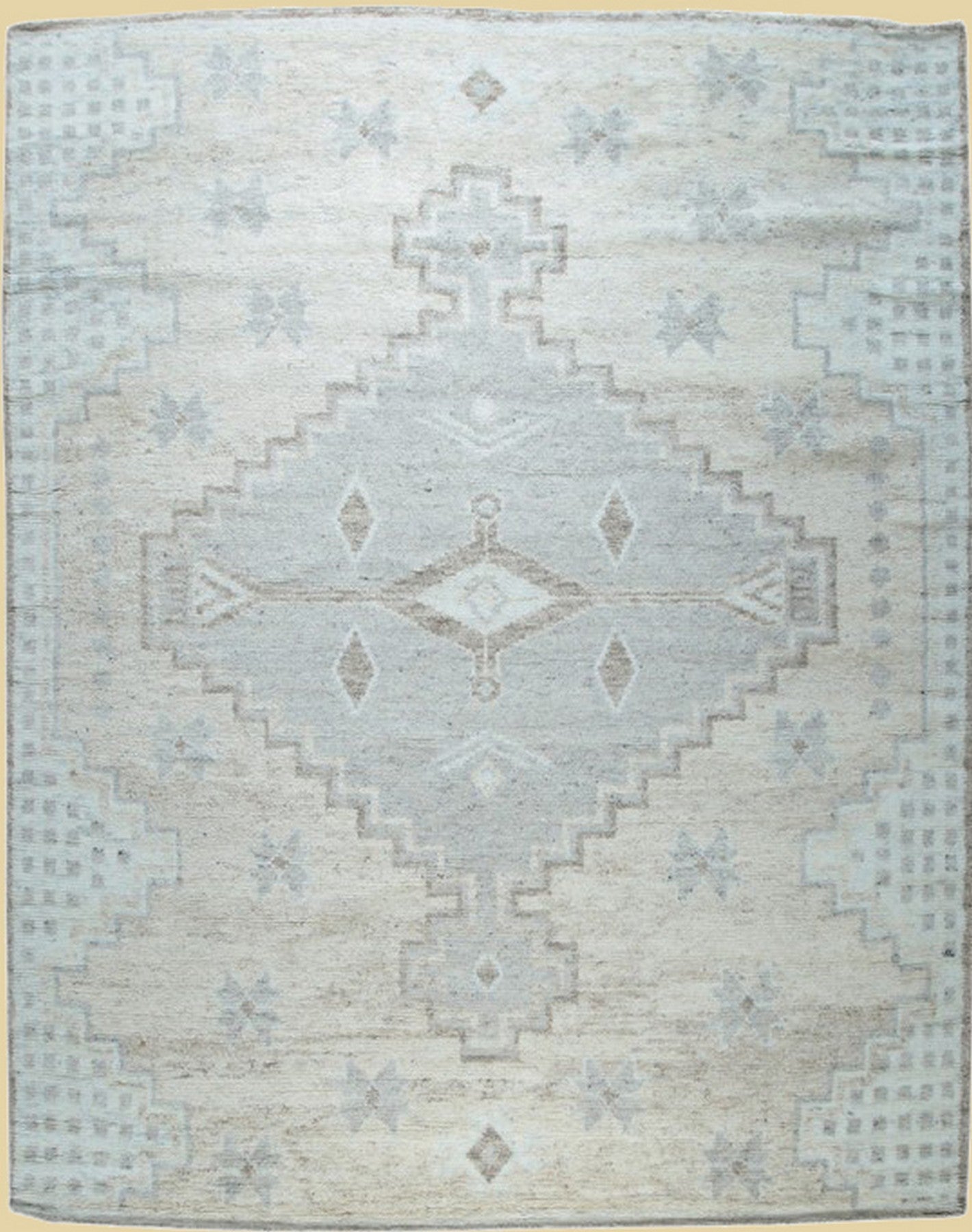Isolated view revealing the Talia Oushak Ivory Hand Knotted Wool Rug's intricate floral medallions and delicate border patterns.