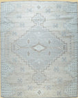 Isolated view revealing the Talia Oushak Ivory Hand Knotted Wool Rug's intricate floral medallions and delicate border patterns.
