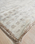 Talia Oushak Ivory Hand Knotted Wool Rug, a subtly textured ivory wool rug with a classic Oushak design, lending warmth and understated elegance to a light-filled living space.