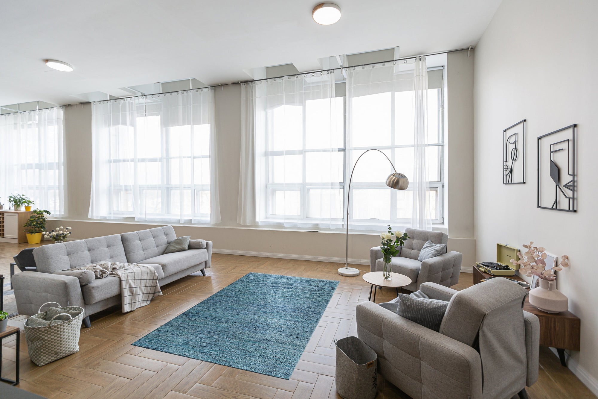 Hand-knotted silk rug, Jade Elegant Blue, shimmering with intricate details, catches light in a close-up view. Threads of deep blues and subtle greens blend seamlessly, demonstrating the rug's luxurious texture and artisan craftsmanship.