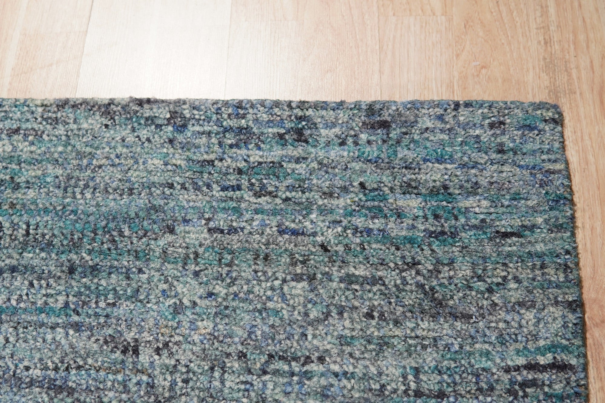 Jade Elegant Blue Hand Knotted Silk Rug, showcasing intricate details and rich blues in a close-up view, highlighting its luxurious silk construction.