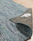 Jade Elegant Blue Hand Knotted Silk Rug, its deep blues and intricate patterns unfolding across a luxurious, hand-knotted silk surface, displayed in a staged interior setting.