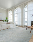 Luna Chloe Green Hand Knotted Silk Rug, its shimmering green silk pile and intricate hand-knotted design accentuating a bright, modern living space with natural light.
