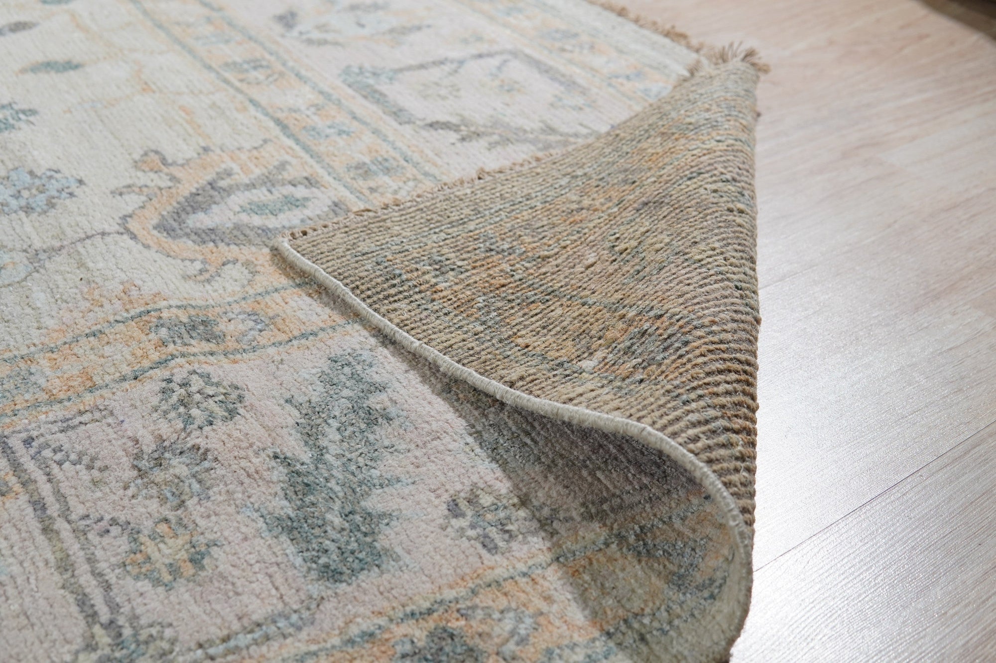 Elena Para Ivory Hand Knotted Silk Rug, shimmering with subtle textures in a bright, airy space; its delicate design lends an understated elegance to the modern interior.